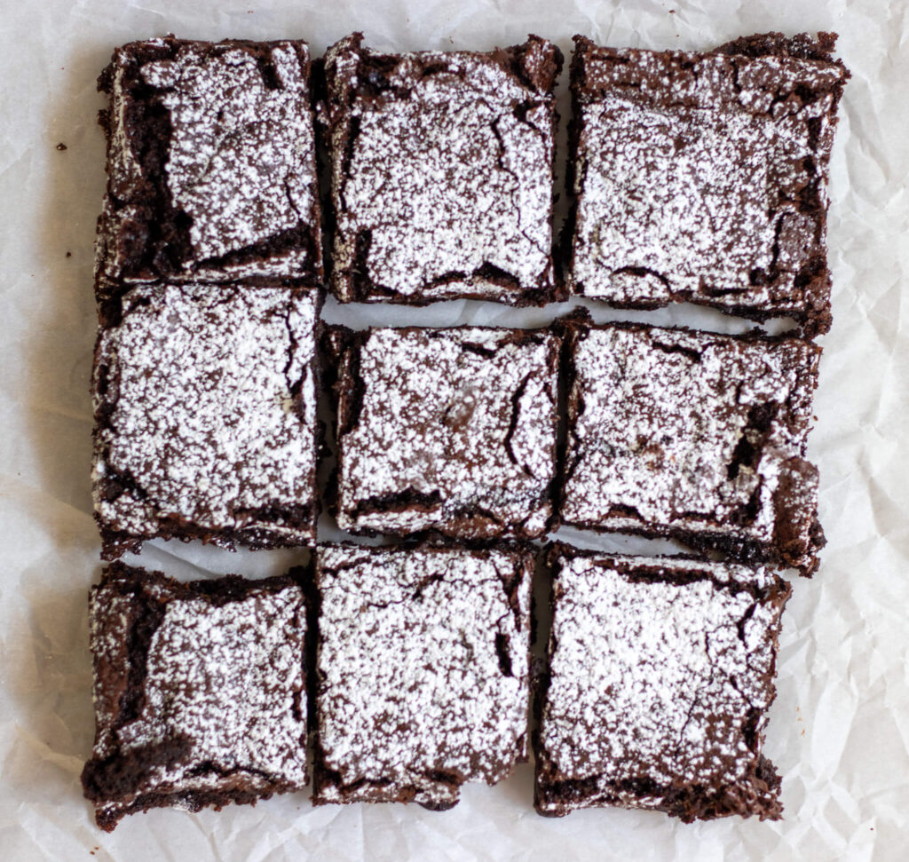 freshly milled flour brownies laying on parchment paper