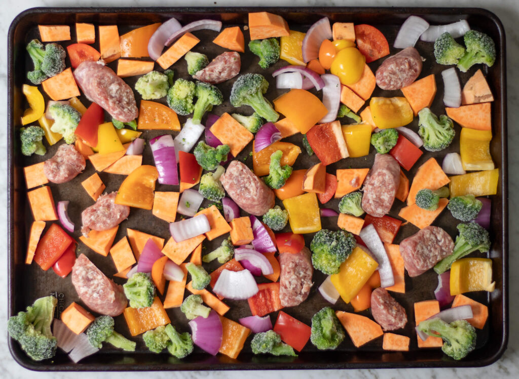 veggies and brats on a sheet pan