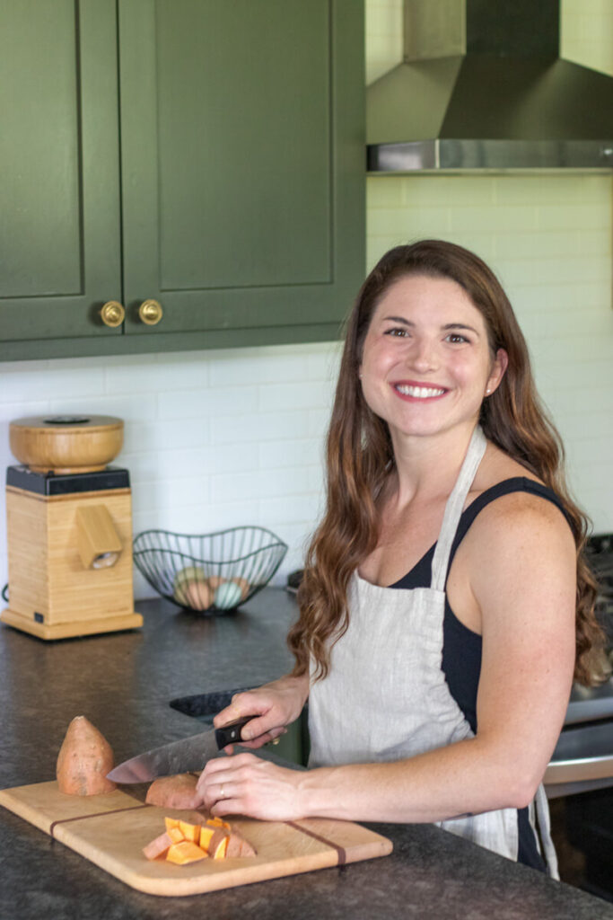 woman chopping a sweet potato